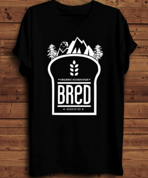 Organic 100% plant-based bread shop needs a Merchandise T-shirt to promote business in ski resort | T-shirt Design by creative gravity
